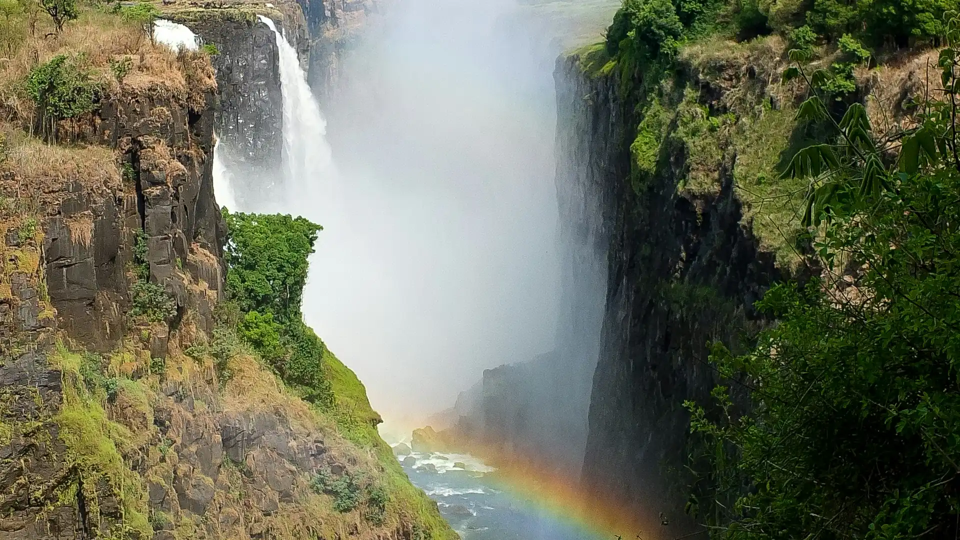 A rainbow rising through the spray at Victoria Falls